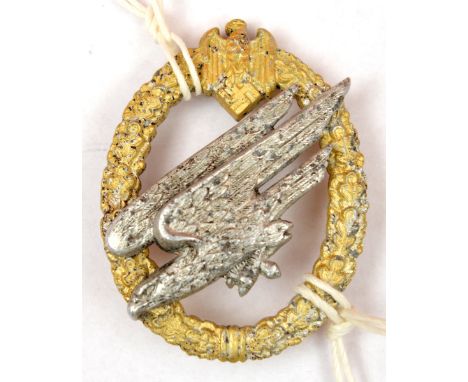 A scarce Third Reich Army Parachutist’s badge, of aluminium alloy, with gold anodised wreath and base metal eagle, GC, (some 