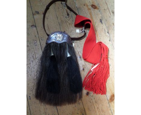 A scarce post 1908 London Scottish OR’s sporran, complete with leather belt; also a sergeant’s red sash. GC                  
