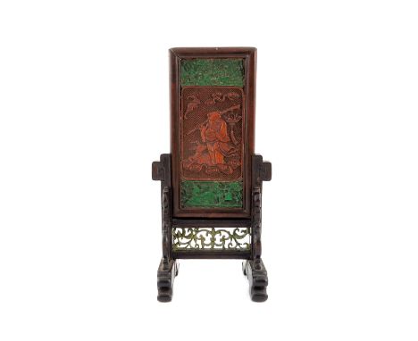 A Chinese carved hardwood and green stained ivory table screen, Qing, the rectangular panel decorated in relief with Shoulao 