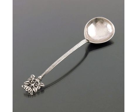 Edward Spencer for the Artificers Guild, an Arts and Crafts white metal spoon, circa 1915, the deep planished bowl with rat t