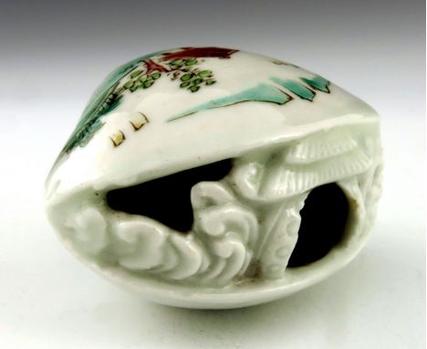A Japanese Hirado porcelain netsuke, Meiji period, 1868-1912, in the form of a clam with internal diorama, width 5.5cm 