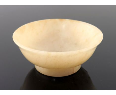 A Chinese pale jade small bowl, gently everted rim, four character incised seal mark to base, height 3cm, diameter 7.5cm