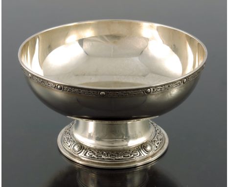 An Arts and Crafts Iona style silver pedestal bowl, W Batty and Sons, London 1938, squat rounded form on splayed foot, applie