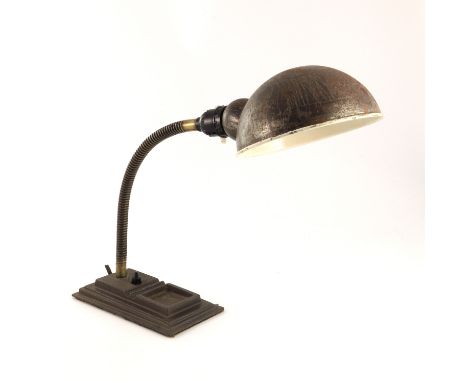 An industrial chrome and black lacquer table lamp, circa 1940s, cast iron cleft foot with square section arm, conical shade, 