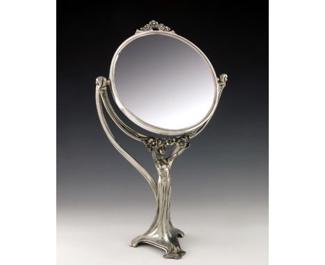 WMF, a Jugendstil silver plated figural swing toilet mirror, modelled as a maiden in sinuous dress holding a floral garland b