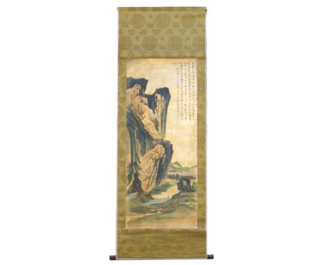 A Chinese scroll painting, mountainous landscape on a gold ground, script upper right, on a textile brocade ground, 195 by 68