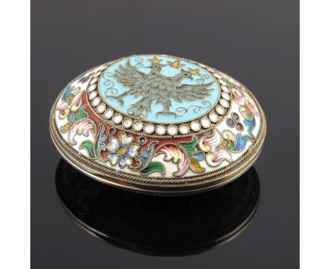 A Russian silver cloisonne enamel snuff box, of oval form with a double headed coronet eagle design on a blue ground to the c