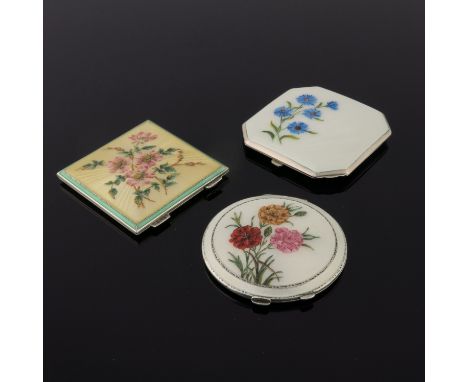 A silver octagonal powder compact in cream guilloche enamel with painted cornflowers, a circular cream enamel compact painted