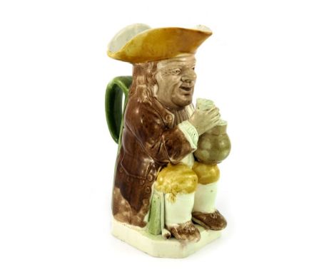 A Ralph Wood family creamware Toby jug of 'Mould 51' type, circa 1780, of traditional form and crisply modelled, seated and h