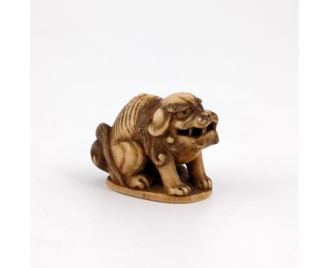 λ A Japanese ivory netsuke, 19th Century or earlier, carved as a recumbent beast, width 3cm