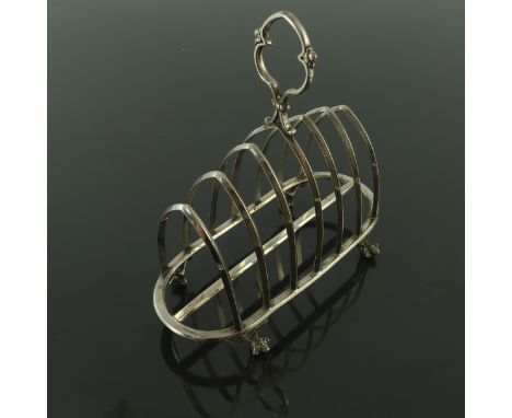 A Gothic Revival silver plated six division toast rack, circa 1835, the graduated triangular section lancet bars on an oval f