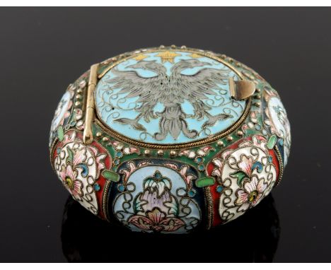 A Russian silver cloisonne enamel snuff box, of circular form, the hinged cover with a double headed eagle with coronets, str