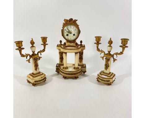 An early 20th Century onyx and gilt metal three piece mantle clock. As found. Loss to gilt chips to onyx. Heavy wear. Not wor