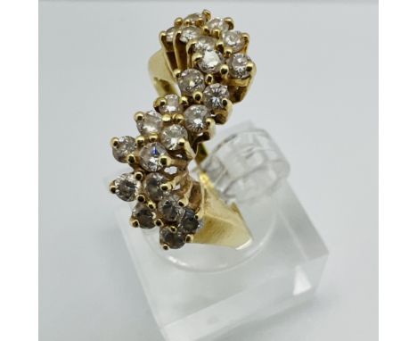 A 14k stamped diamond wave ring - featuring 22 round brilliant cut diamonds, each an estimated 0.03 carats to a total of 0.66