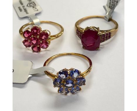 A collection of three 9ct yellow gold rings including a Cruzeiro rubellite ring; a Tanzanite ring and a ruby ring. Size R - S
