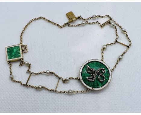 An Edwardian Enamel, diamond and pearl set bracelet. Featuring an emerald green guilloche enamel circular central panel, with