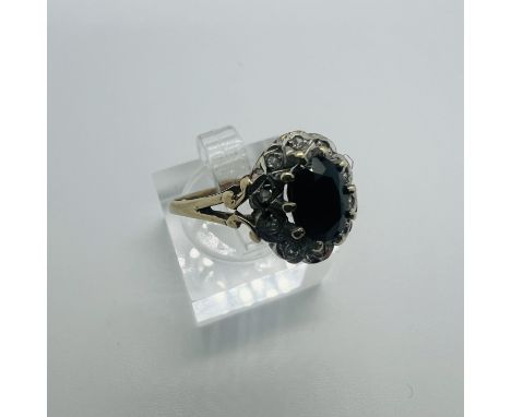 A 9ct sapphire and diamond cluster ring. Size M. Approximate weight 3 grams.