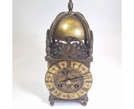 A brass lantern clock with a French 8 day striking movement.&nbsp; In running order with key.&nbsp; 26cm tall