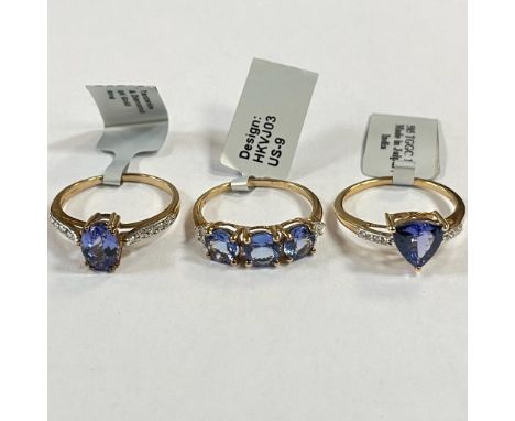 Three Tanzanite and diamond 9ct gold dress rings. To include a Tanzanite trilogy ring, with three round brilliant cut tanzani