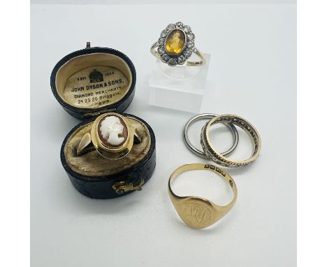 A collection of five rings.&nbsp; Featuring an 18ct gold signet ring with rubbed initials, size P; a 9ct stamped synthetic sp