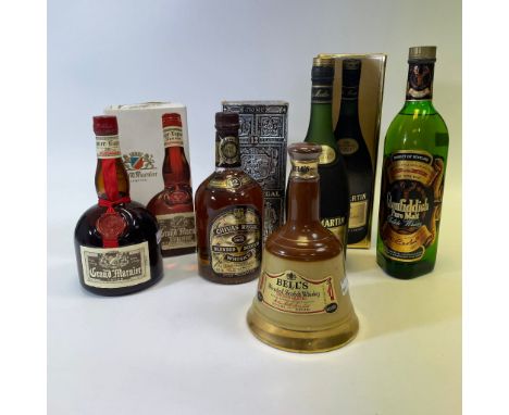 A bottle of Glenfiddich pure malt Scotch Whisky, a bottle of Bells Whisky, a bottle of Grand Marnier Liquor, a bottle of Chiv