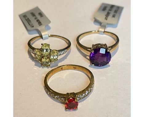 A group of three 9ct yellow gold gem set rings Featuring an Amethyst solitaire ring, and two further rings set with white zir