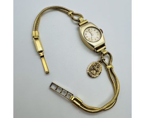 A 9ct yellow gold ladies cocktail watch signed to the dial by Dominant. Featuring a champagne dial, with gold Arabic numerals