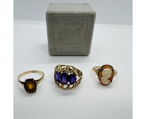 A collection of three gem set vintage rings in an Art Dec era H Samuel ring box. Comprising a 1970s stylised 1970s cocktail r