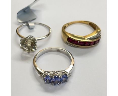 Three 9ct gold rings: Featuring a ruby and diamond ring, a&nbsp;white gold Tanzanite and diamond ring; and a white gold seren