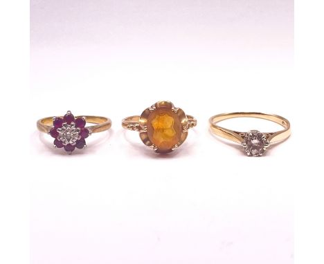 A trio of rings. Featuring a ruby and diamond set cluster ring, stamped "18ct", size K, approximate weight 2.7 grams; along w