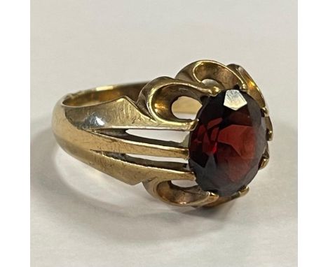 A 9ct yellow gold claw set garnet ring. Featuring an oval mixed cut garnet measuring approximately 1mm x 9mm face up. Size U.