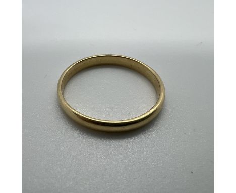 A yellow metal band D-shaped band ring. Size R. Tests as 22ct gold. Approximate weight 2.4 grams