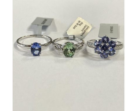 Three 9ct gold gem set dress rings: a 9ct white gold amblygonite & diamond ring, size N 1/2; a 9ct white gold flower shaped t