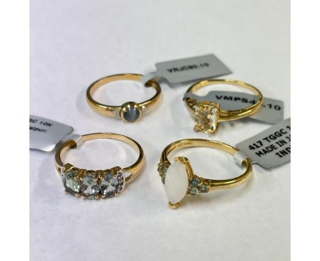 A collection of four 9ct yellow gold gem set rings. To include a distinctive marquise cut opal dress ring.  All size T 1/2. G