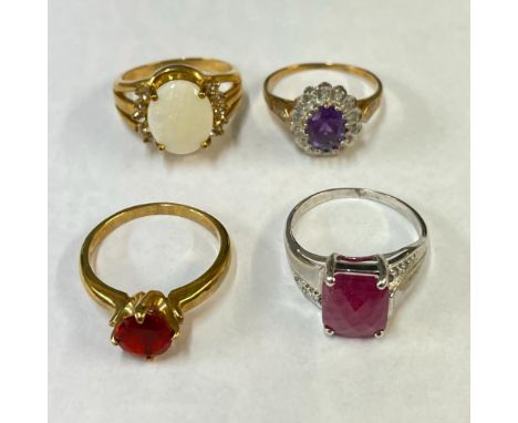 An amethyst and diamond ring in 9ct yellow gold along with three other gem set rings in 9ct gold. To include a ruby and diamo