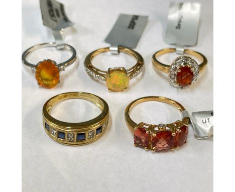 A fire opal and zircon ring in 9ct white gold along with four other 9ct gold rings featuring hydrophane opal, sapphire and di