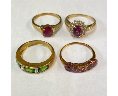 A collection of four gem set 9ct gold rings. Featuring a filled ruby solitaire and a diamond and chrome diopside and diamond 