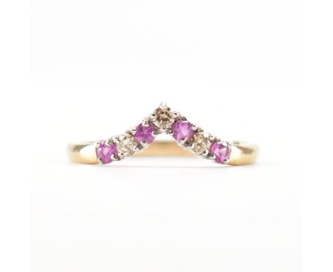 A hallmarked 9ct gold ruby and diamond wishbone ring. The ring set with four rubies and three round brilliant cut diamonds to