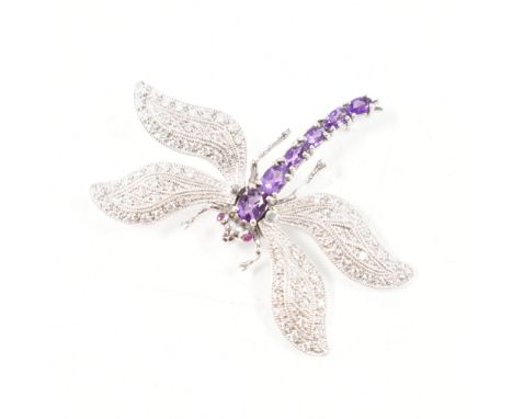 A 925 silver, amethyst, cubic zirconia &amp; ruby articulated dragonfly brooch. The brooch having rubies set to the eyes, pur