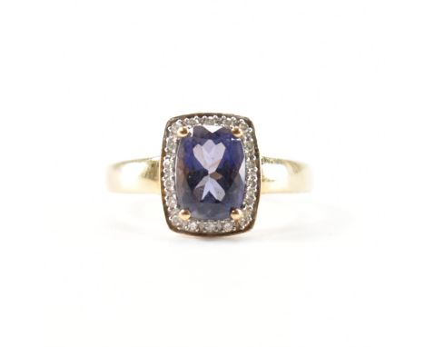 A hallmarked 9ct gold Iolite and diamond ring.&nbsp; The ring set with a mixed cut iolite surrounded by single cut diamonds t