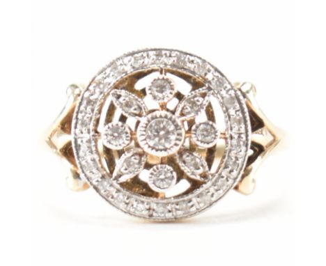 A hallmarked 9ct yellow gold &amp; diamond floral ring. The ring having a round head with punched floral design surrounded a 