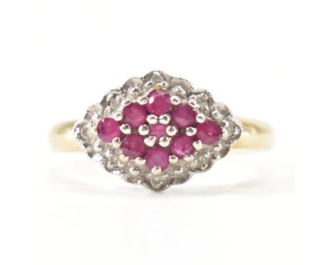 A hallmarked 9ct yellow gold, ruby &amp; diamond cluster ring. The ring having a navette cluster of round cut rubies surround