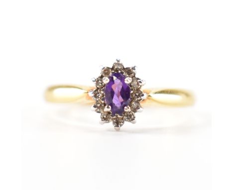 A hallmarked 18ct gold amethyst and diamond halo ring. The ring set with a central oval cut amethyst framed by round single c