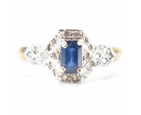 A hallmarked 9ct gold sapphire and diamond ring. The ring set with a central step cut sapphire framed by round brilliant cut 