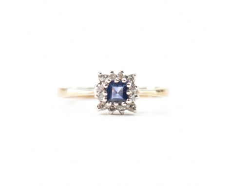 A hallmarked 9ct gold sapphire and diamond cluster ring. The ring set with a central square step cut sapphire framed by a hal