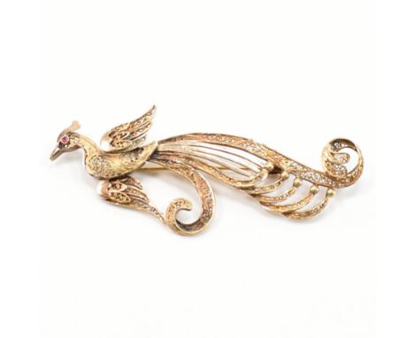 A vintage gold filigree phoenix brooch. The brooch in the form of a phoenix having filigree wire work detailing set with a ro