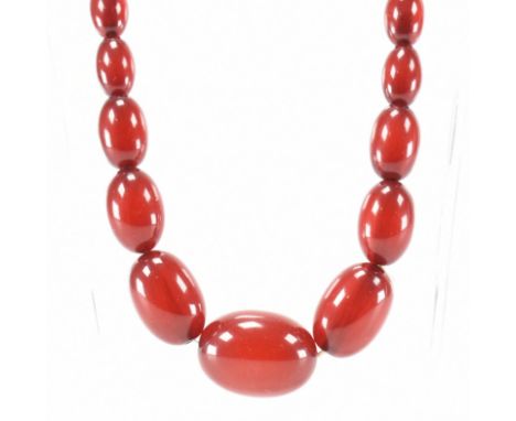 Art deco era cherry amber Bakelite beaded necklace. The necklace having graduating oval beads of cherry coloured Bakelite to 