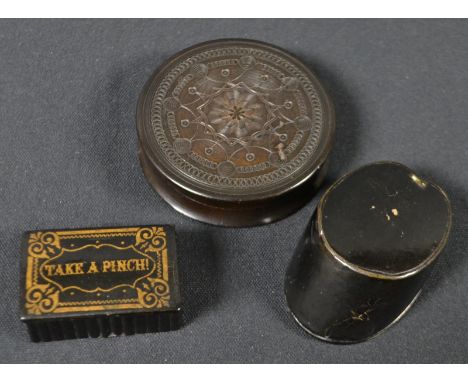 A 19th century lignum vitae circular snuff box, carved with a central roundel, flanked by a field of spheres, push-on cover, 