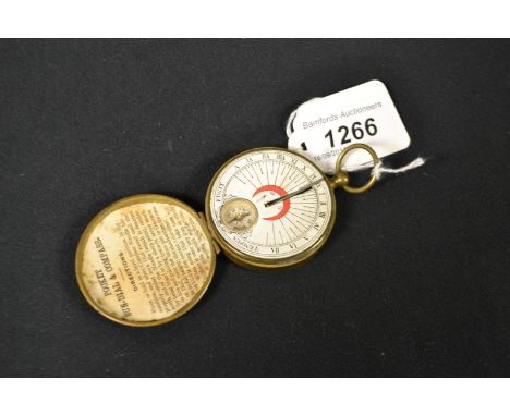 An early 20th century brass pocket sun dial and compass, 4.5cm paper scale, ivorine aide memoir to verso, 7.5cm over loop