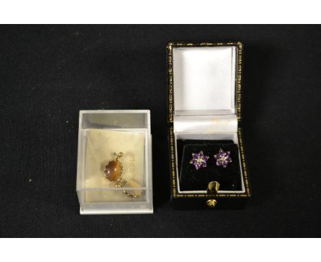 A pair of 9ct gold amethyst earrings; a pair of tiger eye earrings